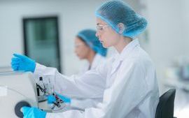 A technician prepares slides for a fully automated digital pathology workflow, where whole slide imaging and an AI algorithm will analyze the tissue.