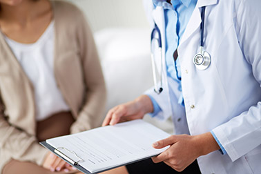 Doctor wearing a stethoscope holding a clipboard