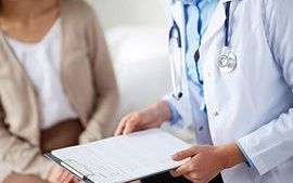 Doctor wearing a stethoscope holding a clipboard