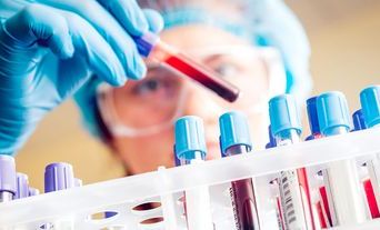 Female scientist handling blood sample tubes resized.jpg