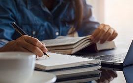 Person writing in book thumbnail.jpg