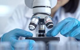 Researcher adjusting slide under microscope_low res.jpg