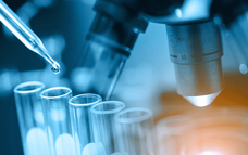 Test vials in front of microscope_higher res thumbnail.png