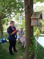 Nurses treat elderly patient at a Hospital at Home clinic