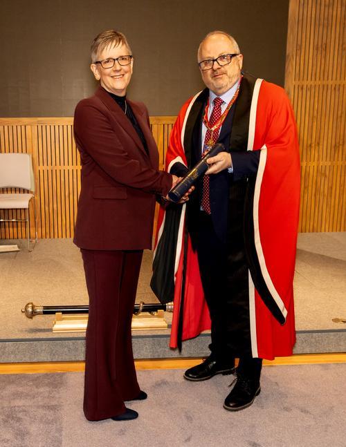 Dr Maria Brereton receives her award from Dr Bernie Croal at the New Fellows Ceremony