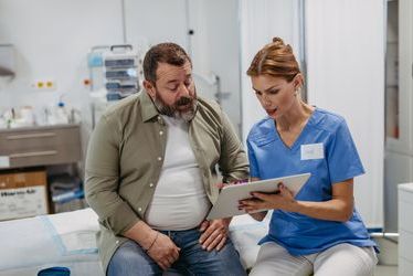 shutterstock_2381590061.jpg Obese man in consultation