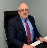 Dr Bernie Croal, RCPath President, sitting at his desk