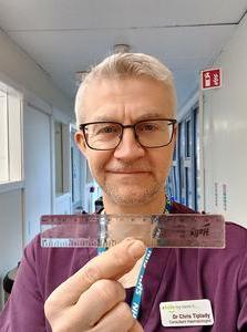 Dr Chris Tiplady with the ruler he was given as a gift