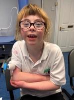 Abi smiling after a successful capillary blood sampling using the TAP device.